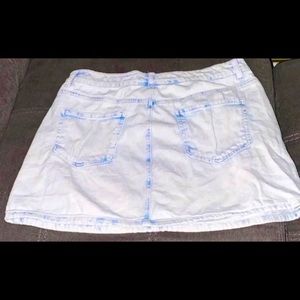 A damaged light blue denim skirt size medium.